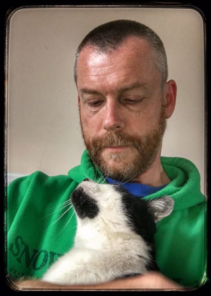 Photo of Fluffies holding a tuxedo cat